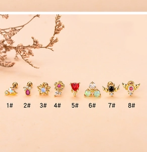 Detailed collection of vintage golden ear studs with colorful zircons in various shapes