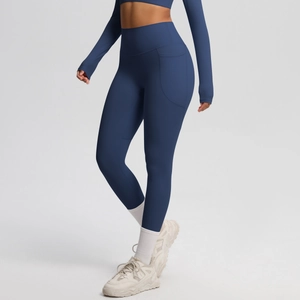 Detail view of high waist yoga leggings in navy blue with functional side pocket