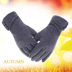 Close-up of dark grey knit gloves with three decorative buttons and leather trim finish