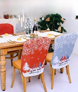 Detail of red and blue Christmas chair covers with festive gnome and snowflake patterns