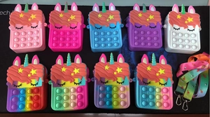Unicorn pop-it silicone bags in multiple colors with matching rainbow shoulder straps