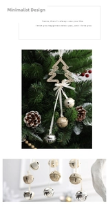 Detail of glitter gold Christmas tree with ribbon and star cutout metal bells