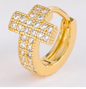 Macro shot of gold-plated hinged hoop earrings with cross-shaped cubic zirconia detail