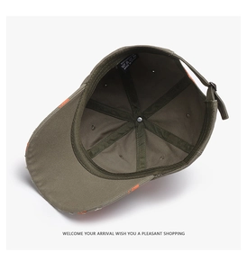 Detail of dark green cotton baseball cap showing internal label and orange distressed brim