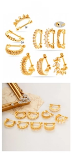 Macro display of nine golden stainless steel U-shaped cartilage studs with cubic zirconia