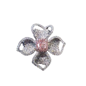 Luxury floral cocktail ring with pink rectangular gemstone and pavé white diamond petals