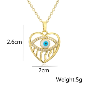 Detail view of 18K gold hollow heart pendant with evil eye motif and 2.6cm dimensions