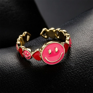 Adjustable gold plated smiling face and heart ring with pink and red enamel details