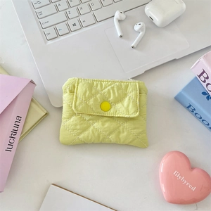 Close-up of quilted nylon coin purse with snap button and diamond stitch pattern