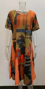 Detail shot of round neck dress featuring orange and blue abstract art print on white background