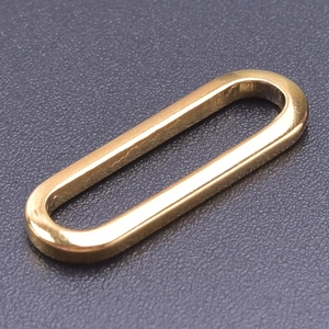 Macro detail of oval gold-plated stainless steel connector for DIY jewelry making
