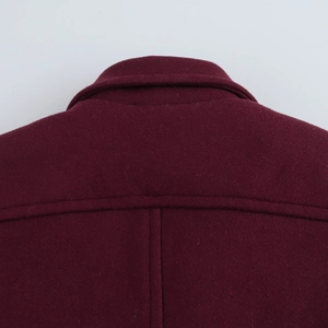 Detailed close-up of the burgundy wool blend coat collar and shoulder fabric texture