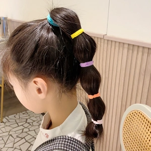 Colorful seamless hair ties shown in a bubble ponytail hairstyle for kids and girls