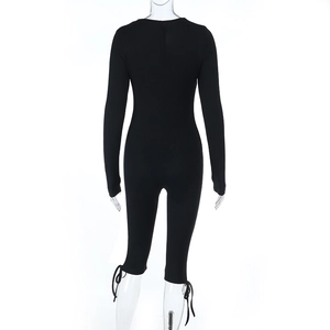Detailed back view of black lace jumpsuit showing adjustable tie-up cuffs and slim fit