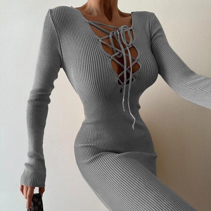 Detail view of the gray slim-fit knitted dress showing V-neck crisscross tie-up design