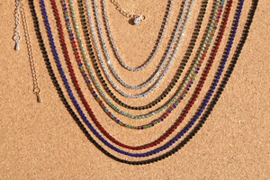 Macro detail of colorful rhinestone clavicle necklaces with adjustable extension chains