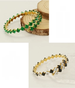Detail of stainless steel bracelets with green emerald and black onyx zircons
