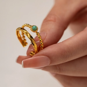 Close-up of French vintage gold-plated rings with natural turquoise and twisted band