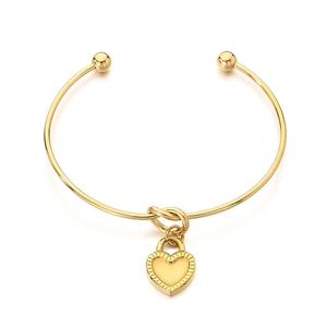 Minimalist gold stainless steel knotted bangle featuring a heart lock pendant and ball ends