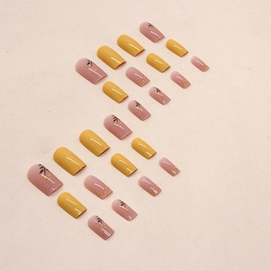 Square yellow press-on nails with golden floral patterns and glossy solid yellow finish