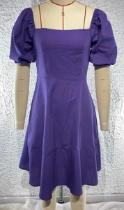 Detail of purple square neck dress with puff sleeves and high waist on a mannequin