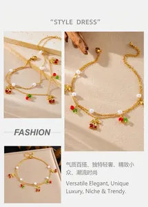 Detail of gold cherry charm anklet with delicate double layers and small white pearls