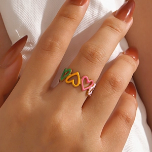 Colorful enamel heart ring in gold plated stainless steel worn on finger