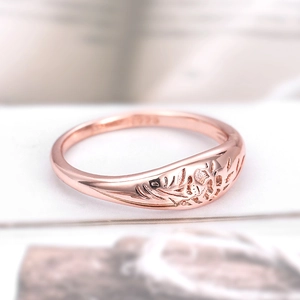 Close-up of rose gold plated ring featuring floral cutouts and S925 hallmark stamp