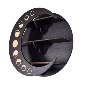 Detail of black moon-shaped wooden shelf featuring golden lunar phase patterns and tiers