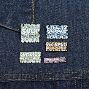 Detailed view of 5 sarcasm slogan enamel pins on denim, including Life is a soup and I'm a fork