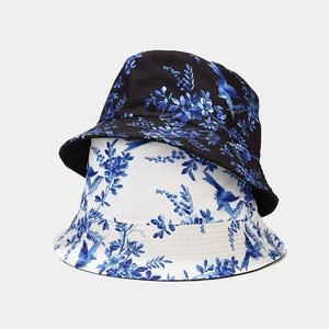 Retro reversible bucket hat with blue floral bird print in black and white styles