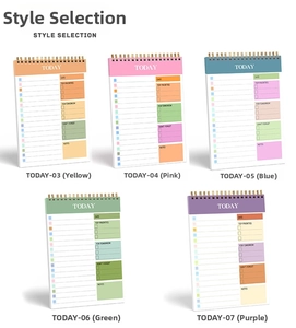 Detailed top view of colorful spiral daily planners with daily schedule layout