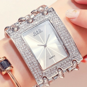 Close-up of luxury women's silver quartz watch with sparkling rhinestones on the wrist