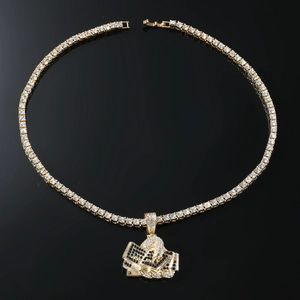 Close-up of golden tennis chain with iced-out hand holding money pendant on black background