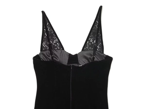 Detail of black velvet dress back featuring delicate floral lace inserts and a zipper