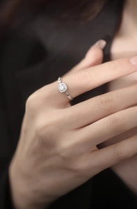 Macro view of adjustable silver chain ring with a brilliant round cluster of pave zircons