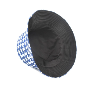 Detail of blue houndstooth fisherman hat with reversible black lining and canvas fabric