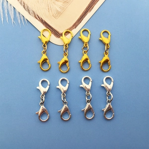 Flat lay of gold and silver double lobster clasps for DIY jewelry connecting