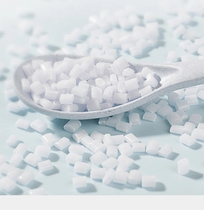 Macro shot of raw white silicone particles in a light blue scoop for bath brush production