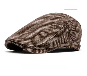 Close-up of brown herringbone tweed newsboy cap featuring side metal adjustment buckle