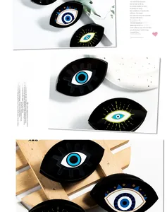 Detailed close-up of a black acrylic evil eye hair claw clip with glossy finish