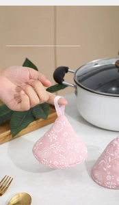 Pink floral cotton pot lid cover with a convenient hanging loop for easy kitchen storage