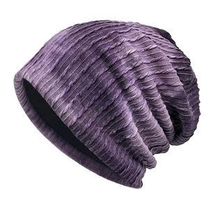 Slouchy cable-knit beanie featuring a purple gradient tie-dye pattern on white background