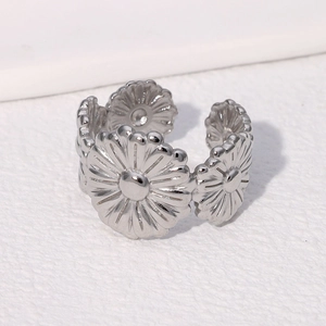 Macro detail of daisy floral pattern on adjustable stainless steel silver open ring