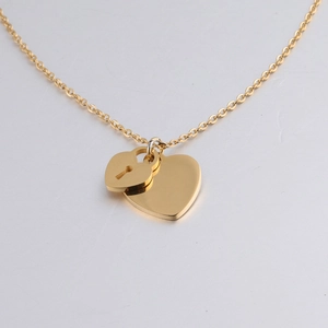 Detailed close-up of golden stainless steel double heart and keyhole pendant necklaces