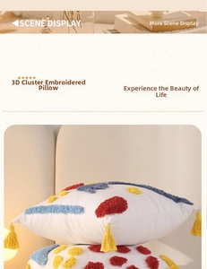 Close-up of tufted embroidery cushion with colorful accents and yellow corner tassels