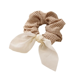 Brown houndstooth plaid fabric scrunchie with beige bow for ponytail hairstyles