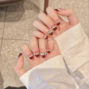 Sparkling berry red French press-on nails with luxury rhinestones and pearl accents