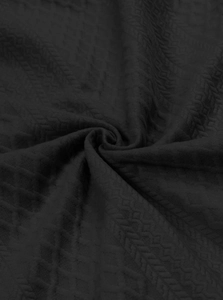Macro view of men's black long-sleeve shirt fabric with geometric diamond texture