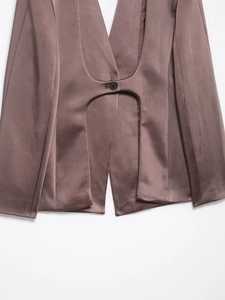 Detail of satin waistcoat featuring a front cutout and single button closure in tan
